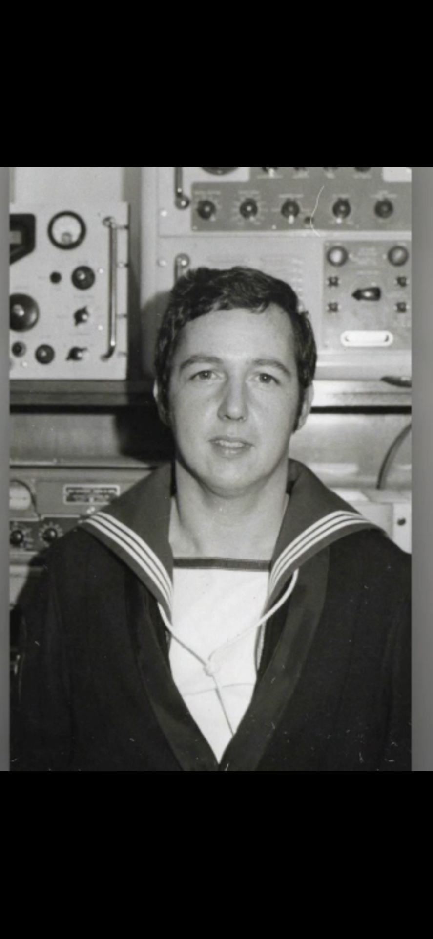 Founder's father in Royal Navy uniform amongst communication equipment